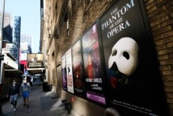 FILE - Broadway posters appear outside the Richard Rodgers Theatre during Covid-19 lockdown in New York on May 13, 2020.