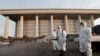 Workers wearing protective suits spray disinfectant as a precaution against the coronavirus at the National Assembly in Seoul, South Korea, Monday, Feb. 24, 2020. South Korea reported another large jump in new virus cases Monday a day after the the…