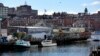 FILE -- Fishing boats are tied up at a wharf on the waterfront in Portland, Maine, on March 11, 2016. 
