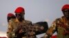 SPLA soldiers stand in a vehicle in Juba December 20, 2013. Talks between South Sudan's President Salva Kiir and African mediators trying to broker a peace deal after six days of clashes between rival army factions are progressing well, Ethiopia's foreign