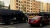 Police vehicles of the Special Weapons and Tactics (SWAT) team are seen after a blast occurred, on a road in Urumqi, Xinjiang Uighur Autonomous Region, May 22, 2014.