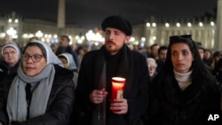 Catholic faithful attend a nightly rosary prayer service for the health of Pope Francis in St. Peter's Square at the Vatican, Feb. 26, 2025. 