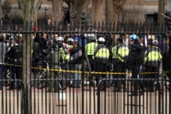 FILE - Police keep watch on the group Antifacist Action during a rally outside of the White House in Washington, Jan. 5, 2019.