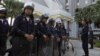 Riot policemen stand guard outside the Department of Special Investigation (DSI) in Bangkok, December 13, 2012. 