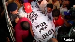 The body of Zahra Shahid Hussain, a senior female politician from cricketer-turned-politician Imran Khan's Tehreek-e-Insaf party, is carried at a hospital in Karachi, May 18, 2013. 