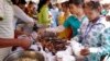 Cambodian garment workers buy some cheap food for their lunch in front of the factory in downtown Phnom Penh, file photo. 