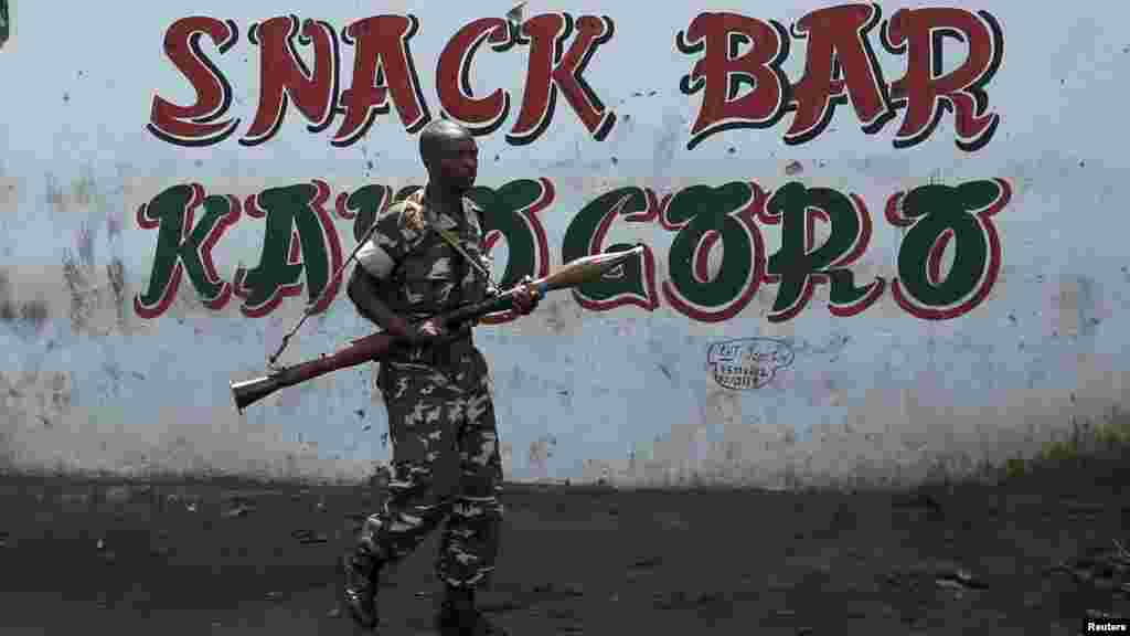 A rescue boat approaches a submerged car on a flooded street after heavy rainfall in Guiyang city, Guizhou province, China.