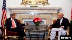 A man picks up a copy of Charlie Hebdo newspaper at a newsstand in Rennes, western France, Jan. 14, 2015. 