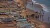FILE - People are pictured on a beach next to fishing canoes in Dakar, Senegal, June 21, 2013. 