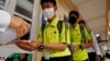 FILE - Students sanitize hands to avoid the contact of coronavirus before their morning class at a high school in Phnom Penh, Cambodia, Tuesday, Jan. 28, 2020.