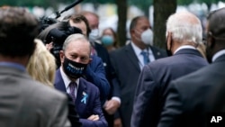 Former New York Mayor Michael Bloomberg, left, visits with Democratic presidential candidate and former Vice President Joe Biden at the National Sept. 11 Memorial in New York, Sept. 11, 2020.