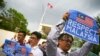 FILE - Members of the youth wing of the National Front, Malaysia's ruling coalition, hold placards during a protest at the North Korea embassy, following the murder of Kim Jong Nam, in Kuala Lumpur, Malaysia, Feb. 23, 2017.