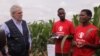 Beatrice Wisiki (R), a beneficiary of an EU-funded irrigation scheme in Zomba district, southern Malawi, tells EU commissioner Christos Stylianides about how she is benefiting from the project. (L. Masina/VOA)