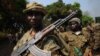 A picture taken on January 10, 2013 shows Seleka rebel coalition members take up positions in a village 12 kilometers from Damara, where troops of the regional African force are stationed. 