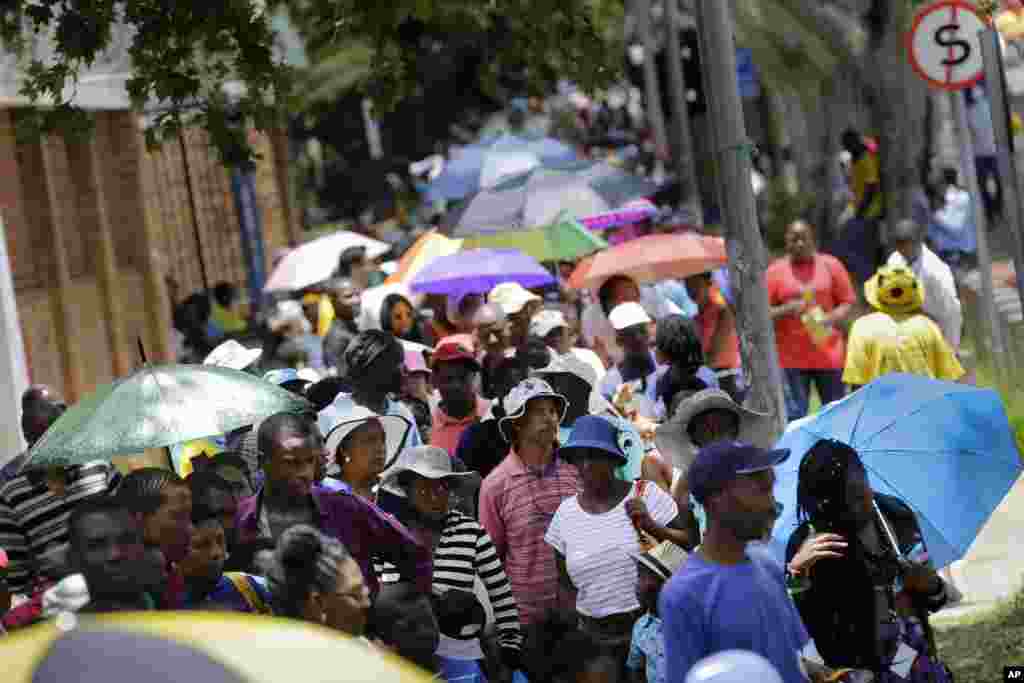 A handout picture released by the Jordanian Queen Rania&#39;s office shows her holding a placard during a demonstration in the capital Amman to express her solidarity with the pilot murdered by the Islamic State (IS) group.