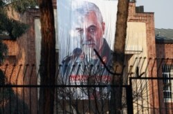 FILE - A picture of Iranian General Qassem Soleimani, killed in a U.S. drone strike at Baghdad airport, is seen on a building which formerly housed the U.S. Embassy in Tehran, Iran, Jan. 7, 2020.