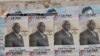 FILE - Election posters for opposition candidate Ayah Paul Abine of the People Action Party are pasted on a wall in the capital Yaounde, Cameroon, Oct. 7, 2011. 