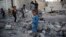 FILE - Children play amid the rubble of a house destroyed by a Saudi-led airstrike in Sana'a, Yemen, Sept. 8, 2015. A cease-fire declared two months ago has not slowed the violence the Yemen, local activists say.