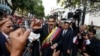 FILE - Venezuela's President Nicolas Maduro, center, greets supporters as he arrives at the National Constituent Assembly's building during the celebration rally of the 20th anniversary of the Venezuelan Constitution in Caracas, Venezuela, Dec. 15, 2019.
