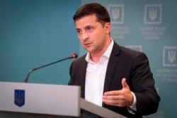 FILE - Ukrainian President Volodymyr Zelenskiy speaks to media in Kyiv, Ukraine, Oct. 1, 2019.