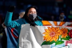 FILE - Tenants' rights advocates march from the Edward W. Brooke Courthouse, Jan. 13, 2021, in Boston. The protest called on the then-incoming Biden administration to extend the eviction moratorium initiated in response to the COVID-19 pandemic.
