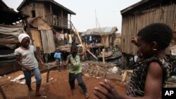 Children play in the Makoko slum, in Lagos, Nigeria where houses accessible only by canoe sit on stilts above polluted waters of the Lagos lagoon, January 21, 2011