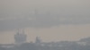 FILE - A cargo ship is seen through air pollution along the Chao Phraya river in Bangkok, Thailand, Jan. 11, 2019. 