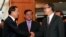 Cambodian Prime Minister Hun Sen, left, shakes hands with opposition party leader Sam Rainsy, right, after a meeting, as Sar Kheng, center, deputy prime minister, looks on at the National Assembly in Phnom Penh, file photo. 