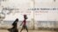FILE - Girls walk on a road in Maroua, Cameroon, March 17, 2016. Amid misconceptions and skepticism surrounding HPV vaccinations in the country, efforts are underway to educate parents about the importance of having girls vaccinated.