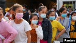 FILE- Garment factory workers and staff wait to receive China's Sinovac coronavirus disease (COVID-19) vaccine at an industrial park in Phnom Penh, Cambodia, on April 7, 2021. REUTERS/Cindy Liu