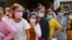Garment factory workers and staff wait to receive China's Sinovac coronavirus disease (COVID-19) vaccine at an industrial park in Phnom Penh, Cambodia, April 7, 2021. REUTERS/Cindy Liu