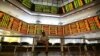 A man rests inside a stock exchange in Kuala Lumpur, Dec. 19, 2013.