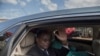 FILE - Cameroonian opposition leader Maurice Kamto (L) sits in the back of a car as he is driven away on October 5, 2019, the day of his release from prison in Yaounde. 