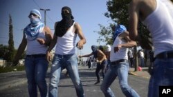 팔레스타인 청년들이 5일 이스라엘 보안군을 향해 돌을 던지고 있다. 