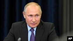 FILE - Russian President Vladimir Putin speaks during his meeting with scientists who received grants for scientific researche in Sochi, Russia. in the Bocharov Ruchei residence in the Black Sea resort of Sochi, Russia, May 17, 2019. 