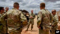FILE - U.S. Army Brig. Gen. Damian T. Donahoe, deputy commanding general, Combined Joint Task Force-Horn of Africa, center, talks with service members during a battlefield circulation, Sept. 5, 2020, in Somalia.