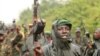 M23 rebel fighters celebrate in the rain at Rumangabo after government troops abandoned the town 23 kilometers north of the eastern Congolese city of Goma, July 28, 2012.