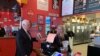 U.S. Vice President Mike Pence orders lunch from Beth Steele, owner of Beth’s Burger Bar in Orlando, Fla., May 20, 2020. (Steve Herman/VOA) 