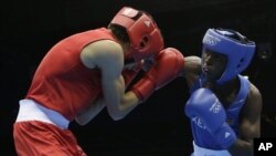 Kenya's Benson Njangiru fights Egypt's Hesham Abdelaal, left, in boxing match at 2012 Summer Olympics July 30, 2012