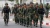 FILE - Soldiers walk outside the National Anti-Corruption Commission office in Nonthaburi province, on the outskirts of Bangkok, Feb. 27, 2014. 
