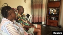 Un couple regarde l'inauguration du président Ali Bongo à Libreville, Gabon, le 27 septembre 2016.