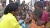FILE - A World Health Organization (WTO) official gives a dose of polio vaccine to Somali children in Tosweyn village, in the Baidoa region, Somalia, Sept. 12, 2000. 