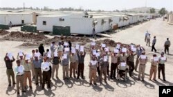 The rising sun turns the sky red and orange behind the U.S. Marine Corps War Memorial in Arlington, Virginia, just outside Washington D.C.