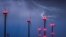 Lightning strikes close to wind turbines in a wind energy park during a thunderstorm near Sieversdorf in eastern Germany.