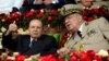 FILE - Algeria's President Abdelaziz Bouteflika gestures while talking with Army Chief of Staff Lt. Gen. Ahmed Gaed Salah during a graduation ceremony of the 40th class of the trainee army officers at a military academy in Cherchell, west of Algiers, Algeria, June 27, 2012.