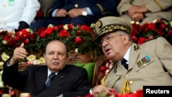 FILE - Algeria's President Abdelaziz Bouteflika gestures while talking with Army Chief of Staff Lt. Gen. 