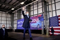 Democratic presidential candidate former Vice President Joe Biden waves after speaking at a rally at Cleveland Burke Lakefront Airport, Nov. 2, 2020, in Cleveland.