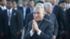 Cambodia's King Norodom Sihamoni, center, greets his government officials upon his arrival for the water festival in front of Royal Palace in Phnom Penh, Cambodia, Sunday, Nov. 13, 2016. The three-day annual festival, started Sunday, dedicates to the kingdom's ancestral naval warriors. (AP Photo/Heng Sinith)