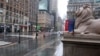 Fifth Avenue in front of the New York Public Library is empty on a rainy day in New York, Monday, April 13, 2020.