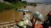 FILE PHOTO - A vendor, foreground, stands on a ferry together with his goods before crossing the Mekong river in Dei Edth village at the outskirt of Phnom Penh, Cambodia, Wednesday, July 22, 2020. (AP Photo/Heng Sinith)